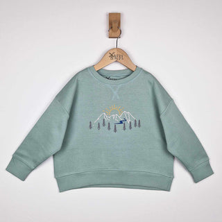 Front view of a sage green kids' sweatshirt with a mountain print.