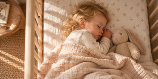 Sleeping toddler in a cot during a calm bedtime routine before the clocks go back