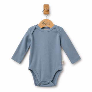 A baby long-sleeve bodysuit in dusty blue ribbed fabric, hanging on a wooden hanger against a clean white background.