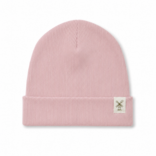 A light pink ribbed knit beanie hat with a folded cuff and a small white square patch featuring a windmill logo on the side, shown against a plain white background.