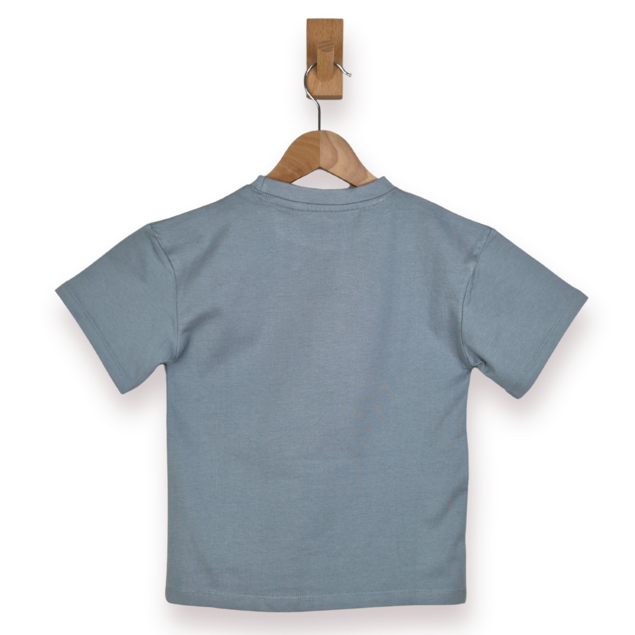Blue t-shirt on a wooden hanger against a white background
