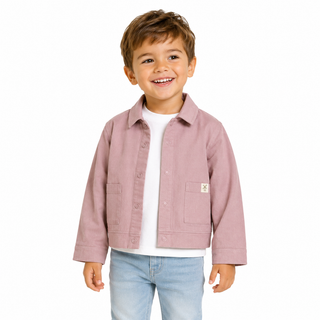 A young boy smiling, wearing a dusty rose pink jacket over a white t-shirt and light blue jeans, photographed against a solid white background.
