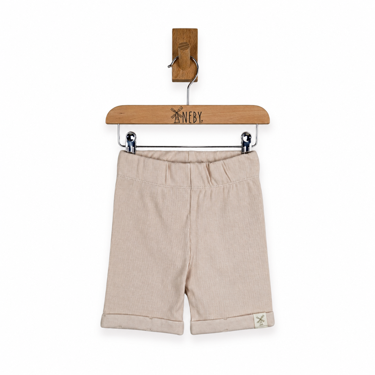 Beige cotton shorts with a gathered elastic waistband and rolled cuffs, hanging from a wooden hanger on a white background.