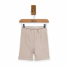 Beige cotton shorts with a gathered elastic waistband and rolled cuffs, hanging from a wooden hanger on a white background.