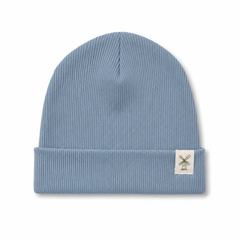 A light blue ribbed knit beanie hat with a folded cuff and a small white square patch featuring a windmill logo on the side, shown against a plain white background.