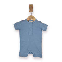 A baby short-sleeve romper in dusty blue, hanging on a wooden hanger, against a plain white background.