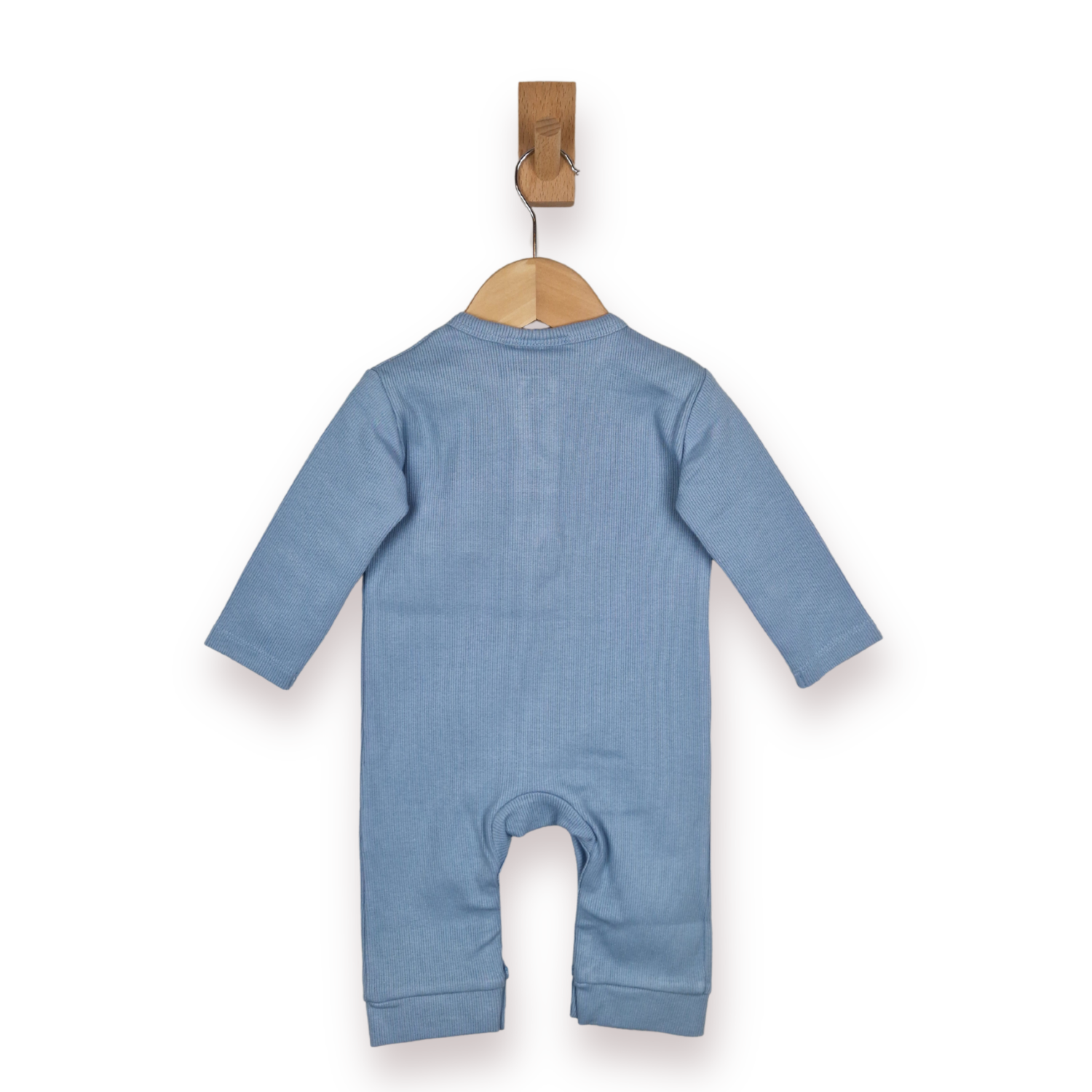 A dusty blue long-sleeve baby romper shown from the back, hanging on a wooden hanger with a wooden peg against a plain white background.