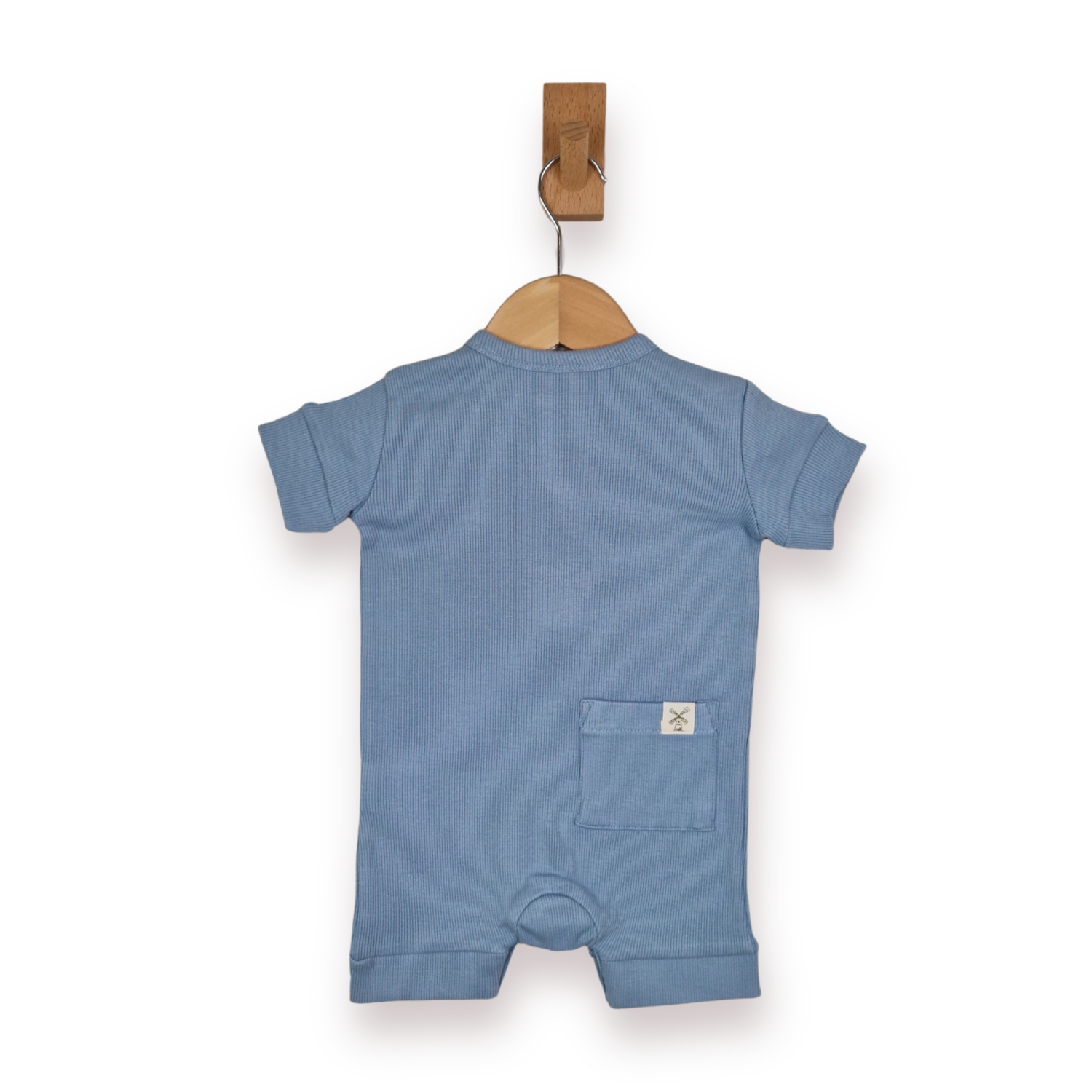 A baby short-sleeve romper in blue, hanging on a wooden hanger from a wall hook against a white background.