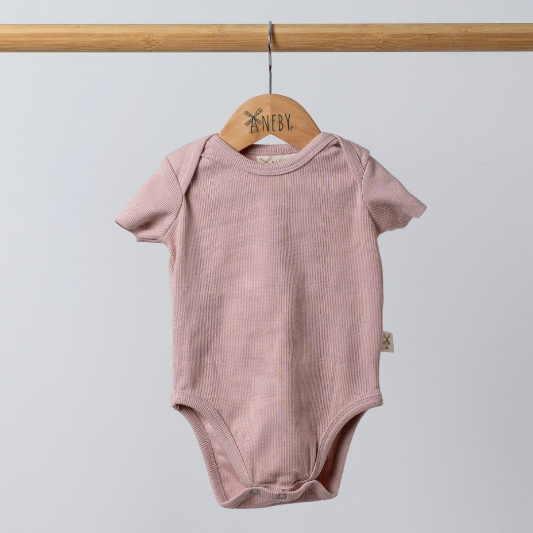 Dusty pink short sleeve playsuit with envelope neck opening and crotch dye to match poppers