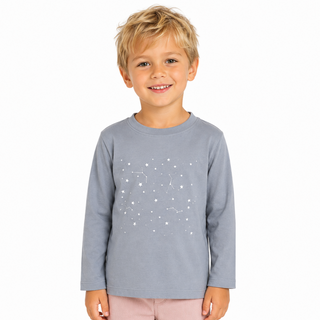 Child wearing a gray long-sleeve shirt with white star patterns on a white background