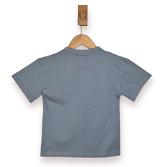 Blue t-shirt on a wooden hanger against a white background