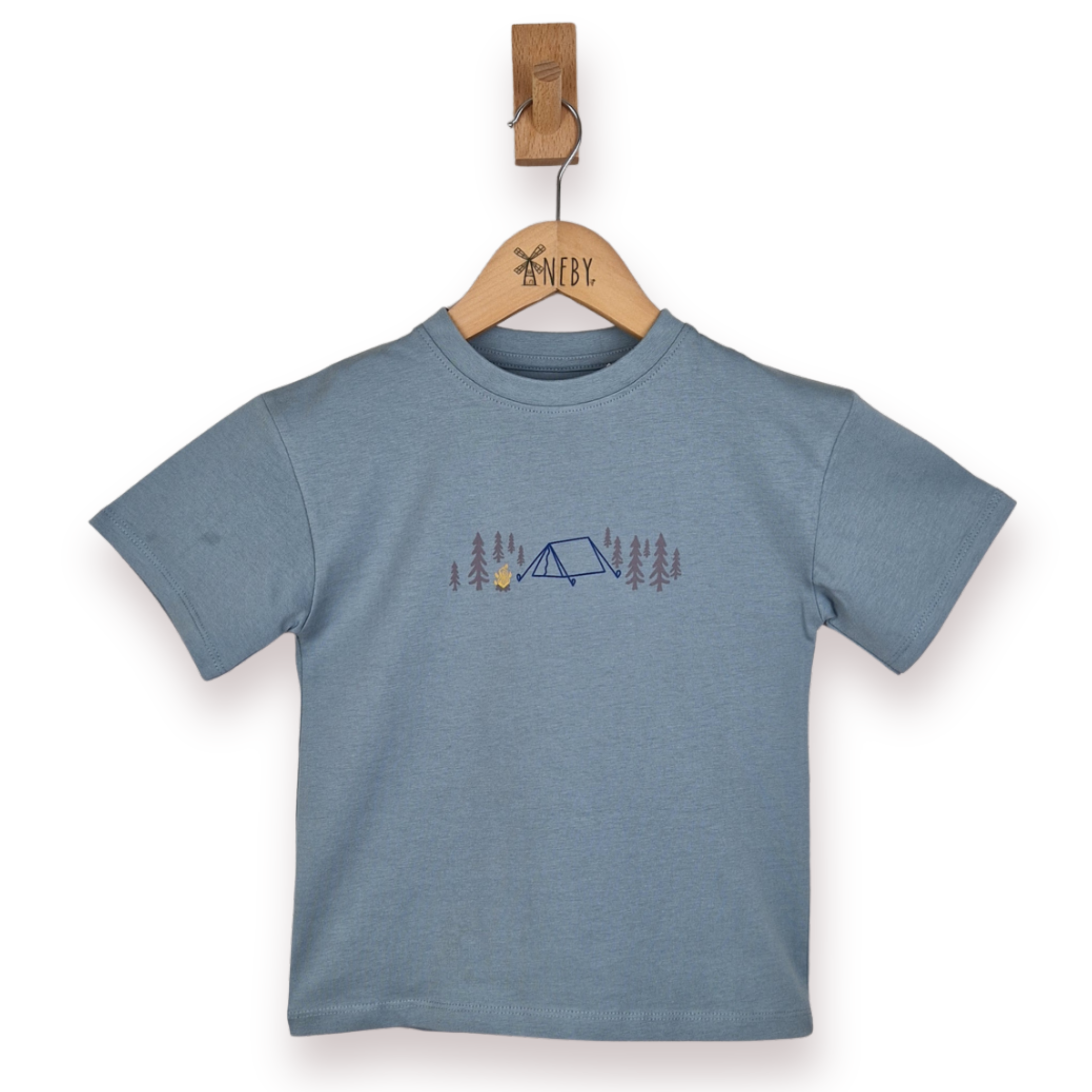 Blue t-shirt with a camping design on a wooden hanger against a white background