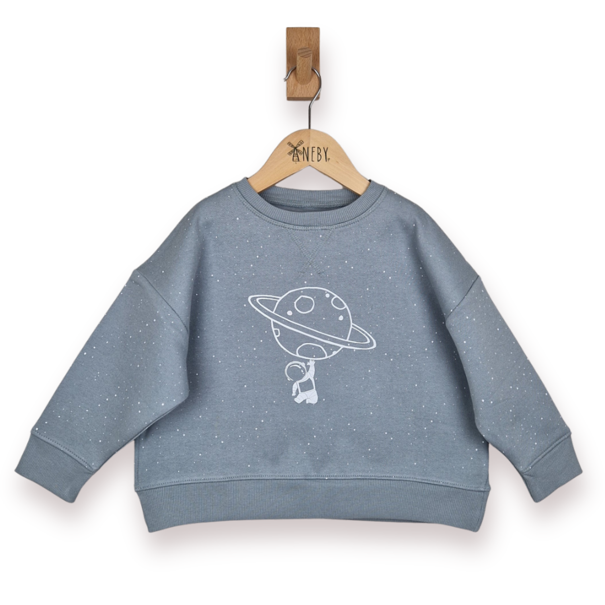 Blue grey children's sweatshirt with space-themed design on a hanger against a white background