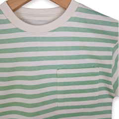 Close up photo of a boys green and ecru stripe t -shirt on a white background.