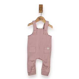 A dusty pink rib cotton baby romper hanging on a wooden hanger with a small wooden hook above it, against a plain white background.
