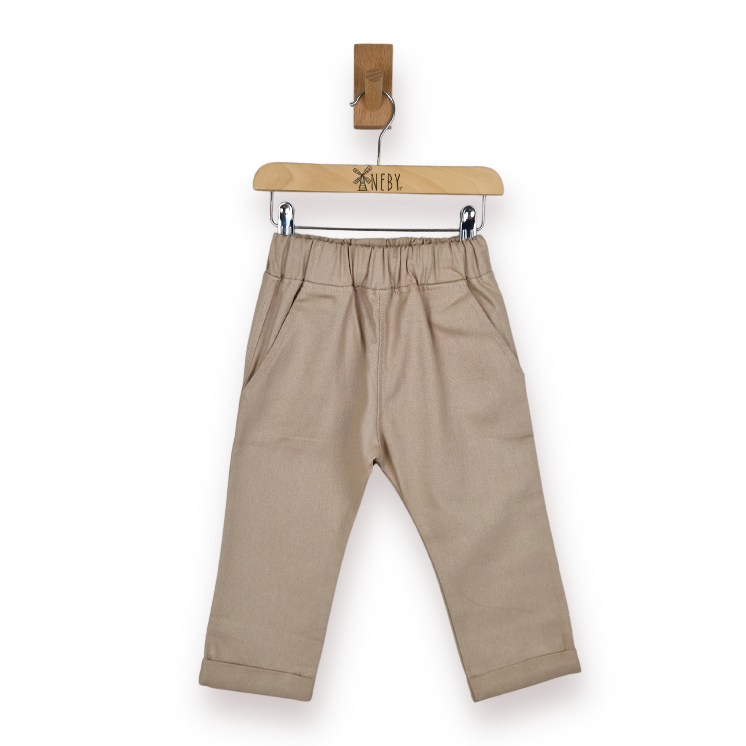 A pair of toddler's beige trousers with an elastic waistband and side pockets, hanging from a wooden hanger against a plain white background.
