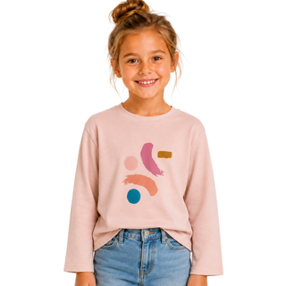 Young girl wearing a light pink sweatshirt with colorful abstract designs on a white background