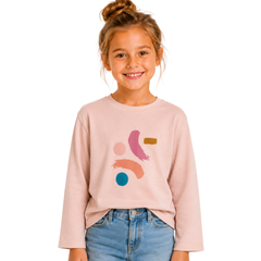 Young girl wearing a light pink sweatshirt with colorful abstract designs on a white background
