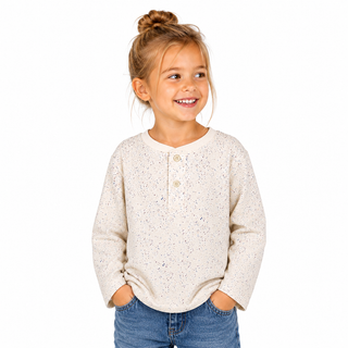 Young girl wearing a cream sweater and blue jeans on a white background