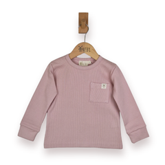 A dusty pink ribbed long-sleeve top for kids, featuring a chest pocket with a small logo patch, hanging on a wooden hanger with a wooden peg against a white background.