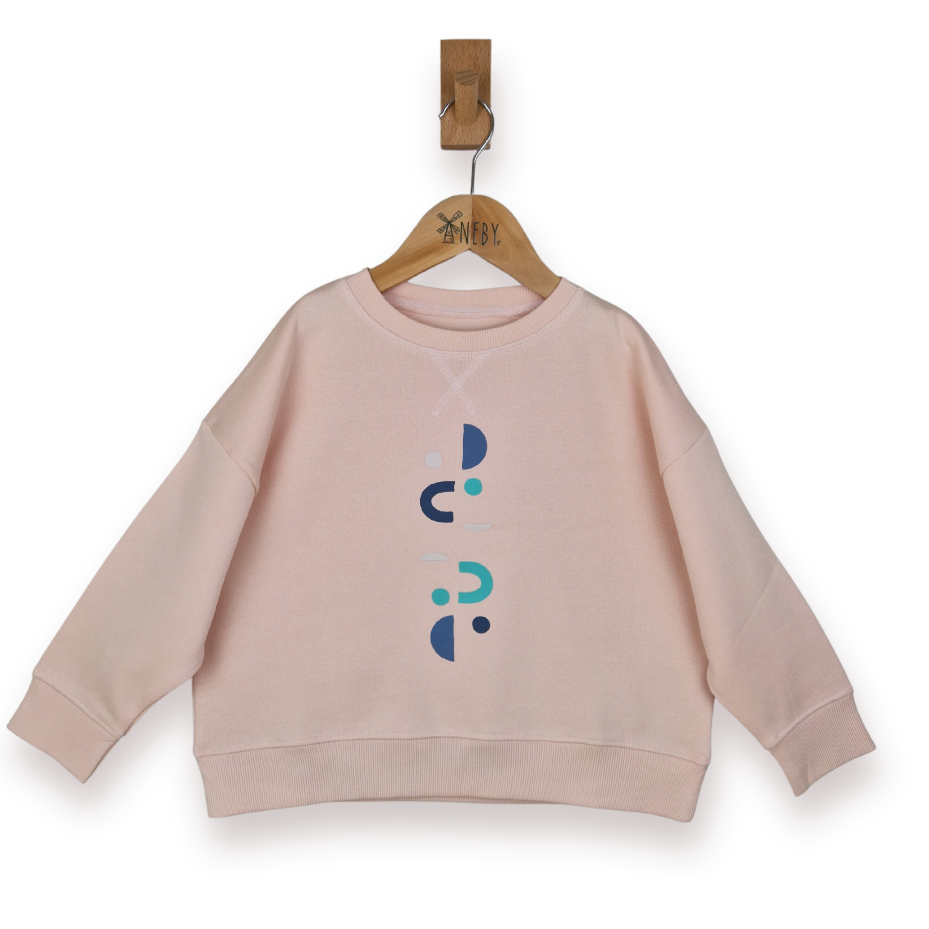 Pink sweatshirt with abstract designs on a hanger against a white background