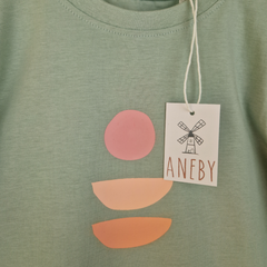 Close up of design on kids' long sleeve green t-shirt. 