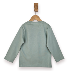 Green long-sleeve shirt on a wooden hanger against a white background