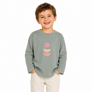 Child wearing a green long-sleeve shirt with pink and orange abstract design on a white background