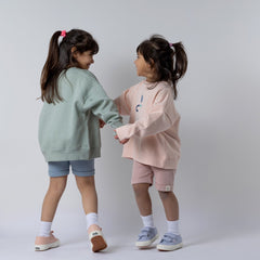 Two young models holding hands modelling Aneby sweatshirts