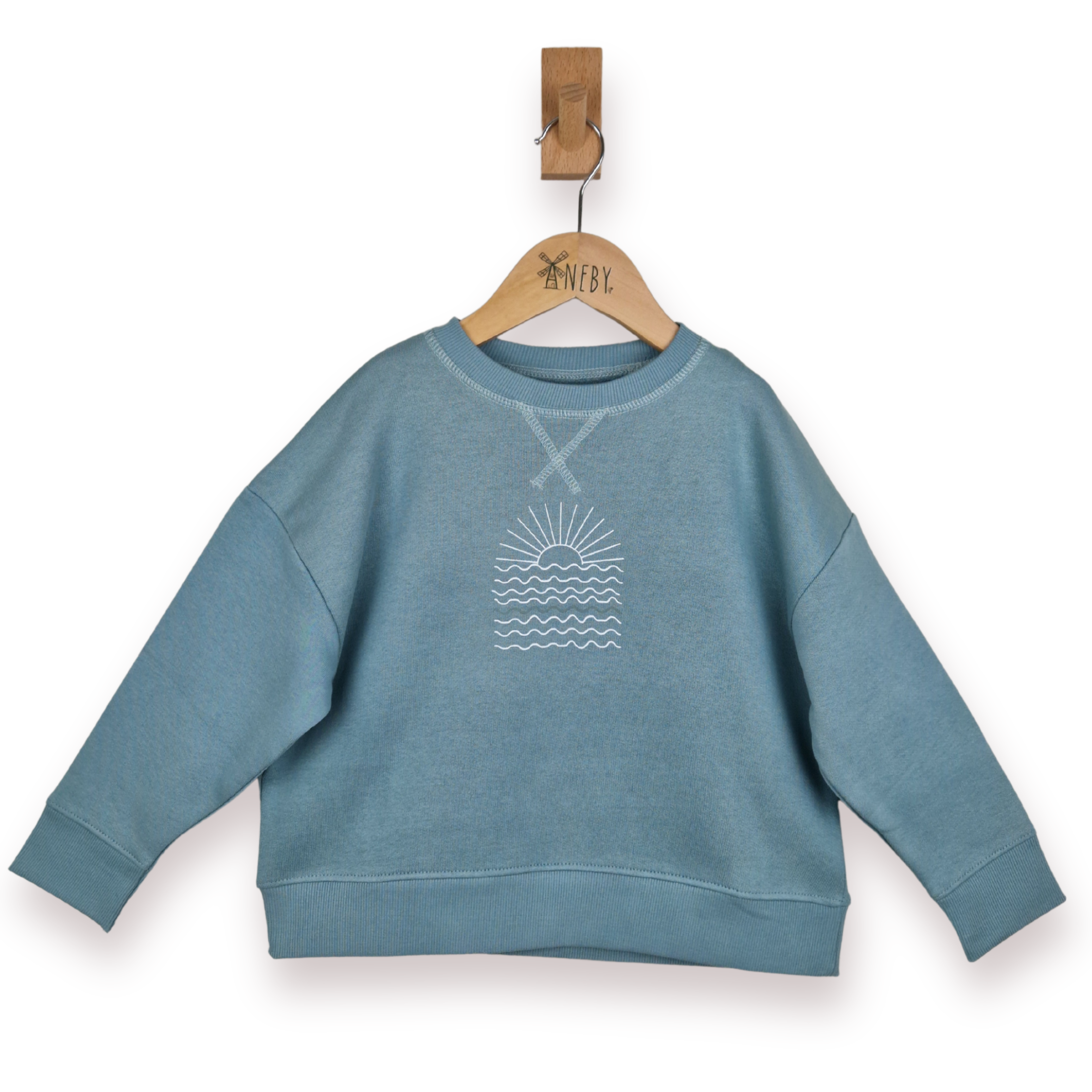 Blue sweatshirt with a wave design on a hanger against a white background