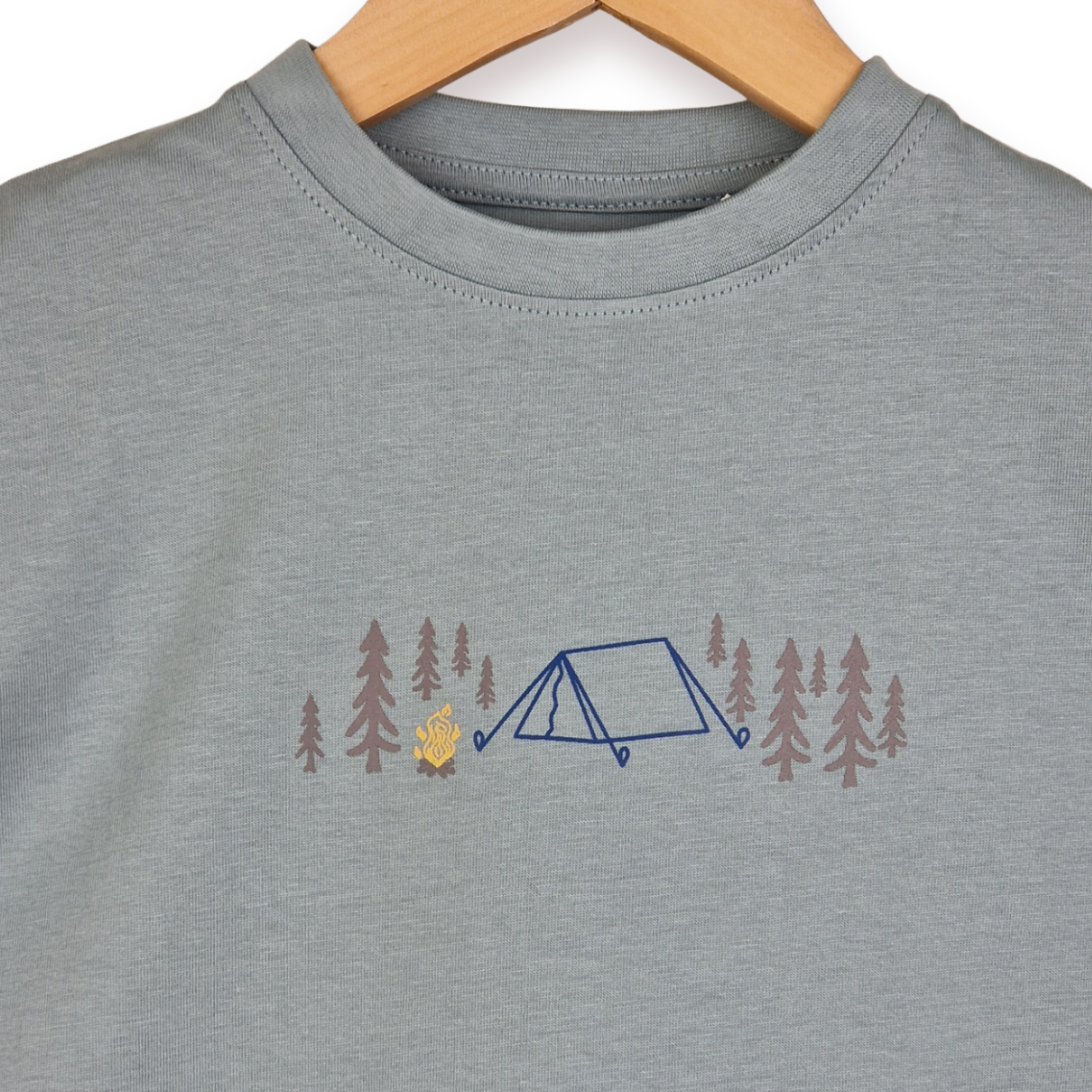 Gray t-shirt with a camping design on a hanger