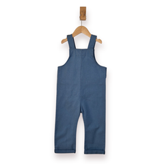 A baby's blue denim overall romper hanging on a wooden hanger against a plain white background.