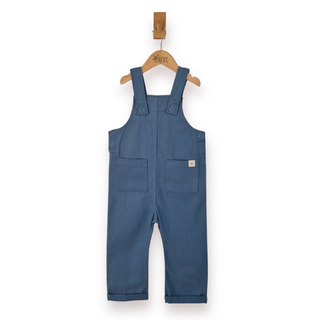 A pair of baby blue denim overall jumpsuit hanging on a wooden hanger against a plain white background.