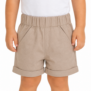 A child wearing light beige elastic-waist shorts with rolled cuffs and side pockets, paired with a white top, shown against a plain white background.