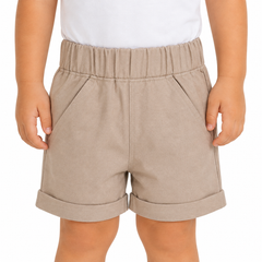 A child wearing light beige elastic-waist shorts with rolled cuffs and side pockets, paired with a white top, shown against a plain white background.