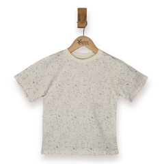 Kids ecru t-shirt with speckled pastel print and patch pocket on a wooden hanger against a white background