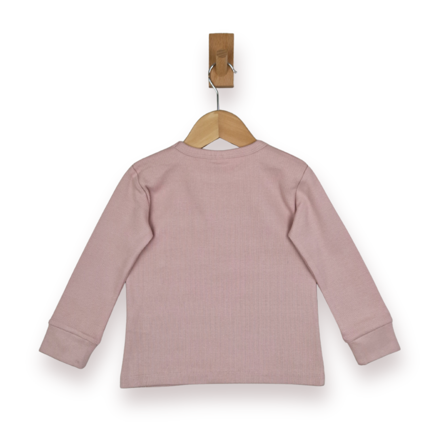 A dusty pink long-sleeve ribbed knit top shown from the back, hanging on a wooden hanger with a wooden peg against a plain white background.