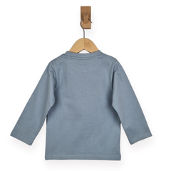 Blue long-sleeve shirt on a wooden hanger against a white background
