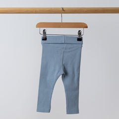 Back view of blue jersey rib leggings on wooden coat hanger