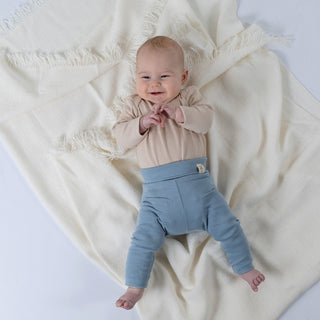 Slate blue jersey rib cotton leggings on baby with Aneby windmill hem tag on waistband