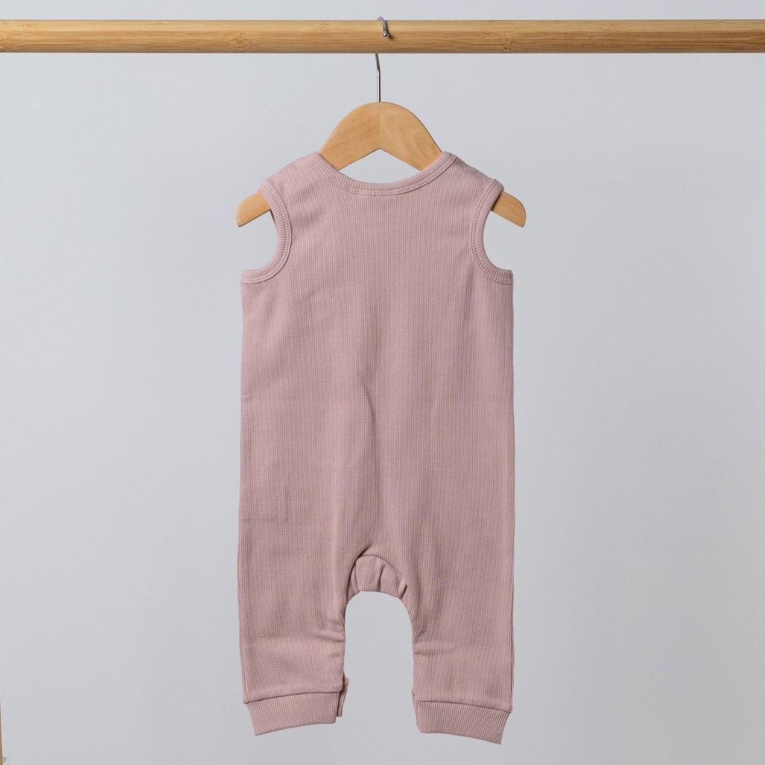 Rear view of dusty pink baby romper with crotch poppers and shoulder poppers