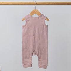 Rear view of dusty pink baby romper with crotch poppers and shoulder poppers
