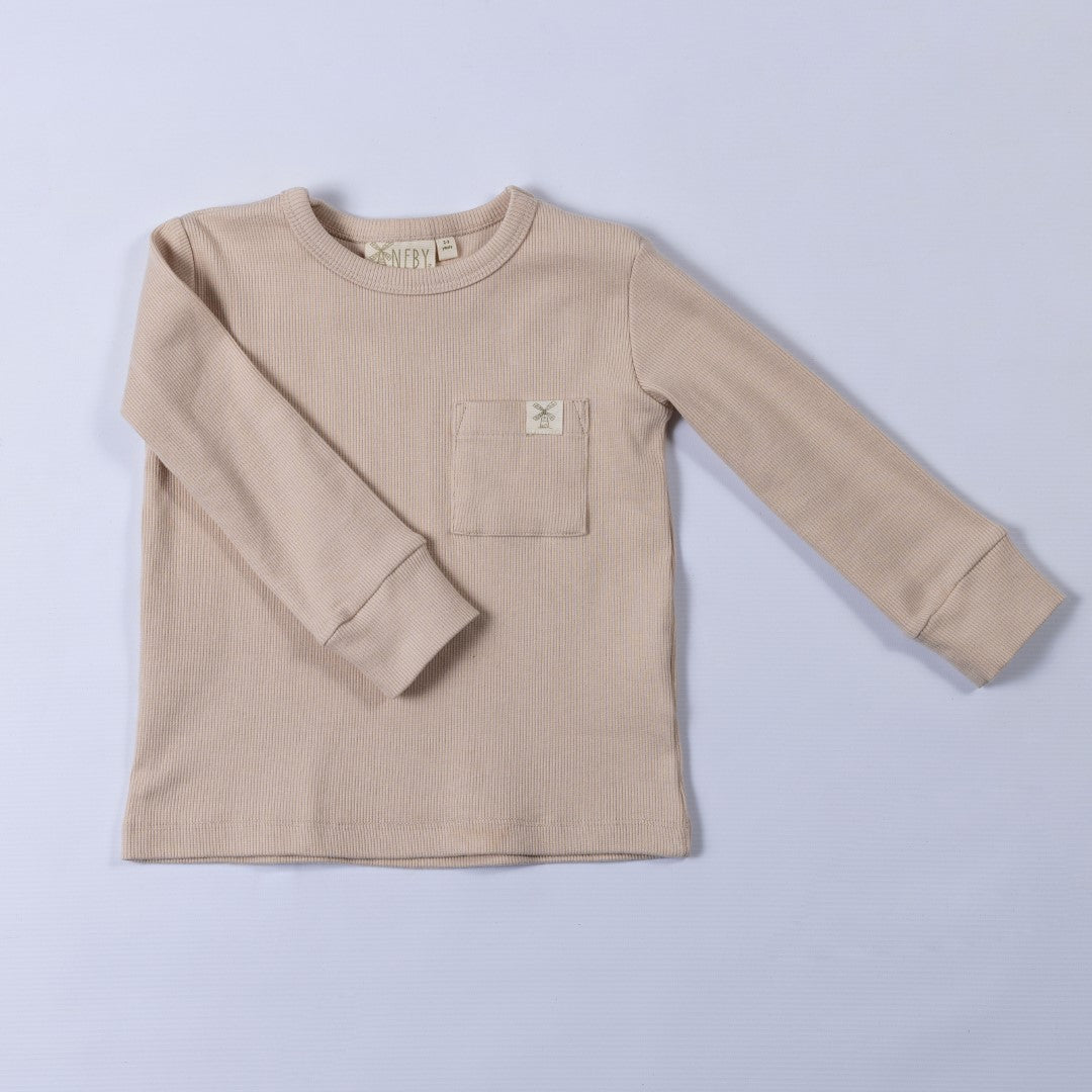 Neutral oat long sleeve top with cuffs and square chest patch pocket with Aneby windmill hem tag