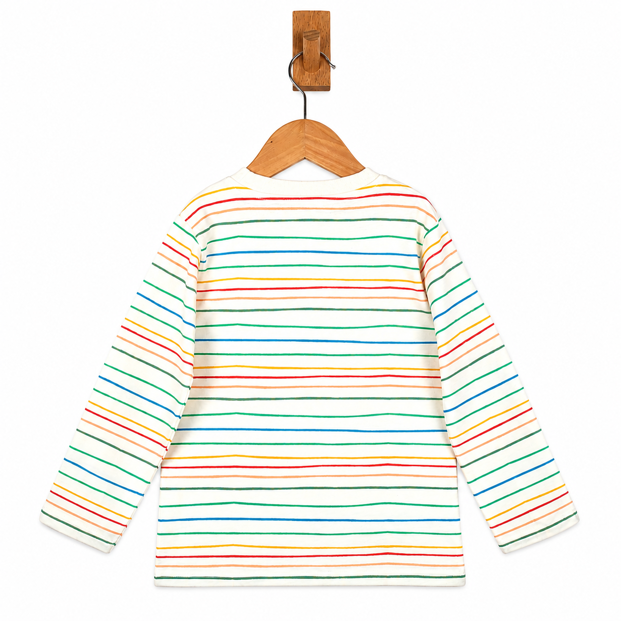 A long-sleeve children's shirt with horizontal rainbow stripes in red, orange, yellow, green, blue, and purple on an off-white base, hanging on a wooden hanger from a wooden peg against a white background.