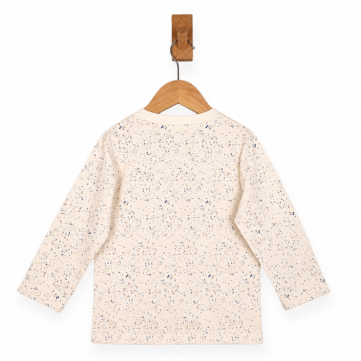 Speckled long-sleeve shirt on a wooden hanger against a white background