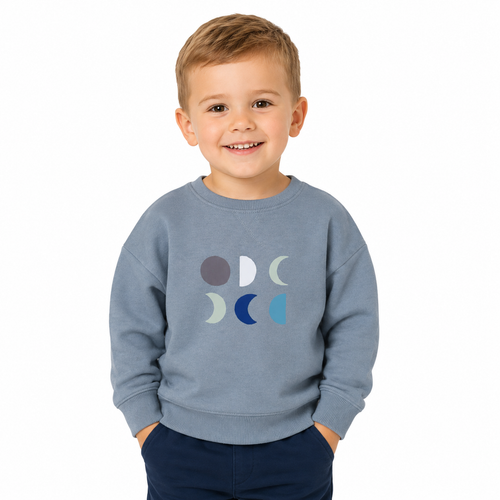 Child wearing a blue grey sweatshirt with colourful moon phases design on a white background