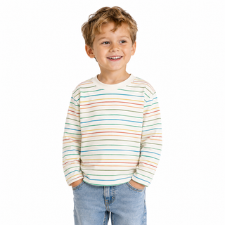 Boy wearing a long sleeve multicoloured stripe t shirt. Standing against a white background. 