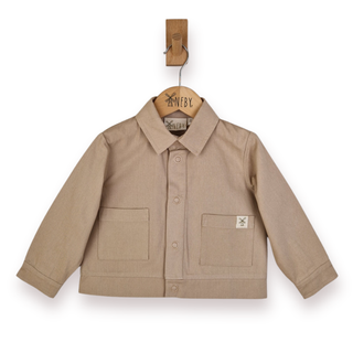 A beige long-sleeve button-up shirt jacket with two front patch pockets, hanging on a wooden hanger from a wooden peg against a white background.
