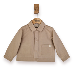 A beige long-sleeve button-up shirt jacket with two front patch pockets, hanging on a wooden hanger from a wooden peg against a white background.