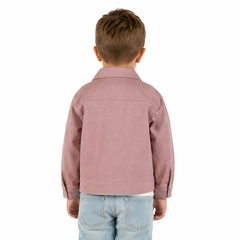 A young boy viewed from behind wearing a dusty rose pink jacket and light blue jeans, set against a plain white background.
